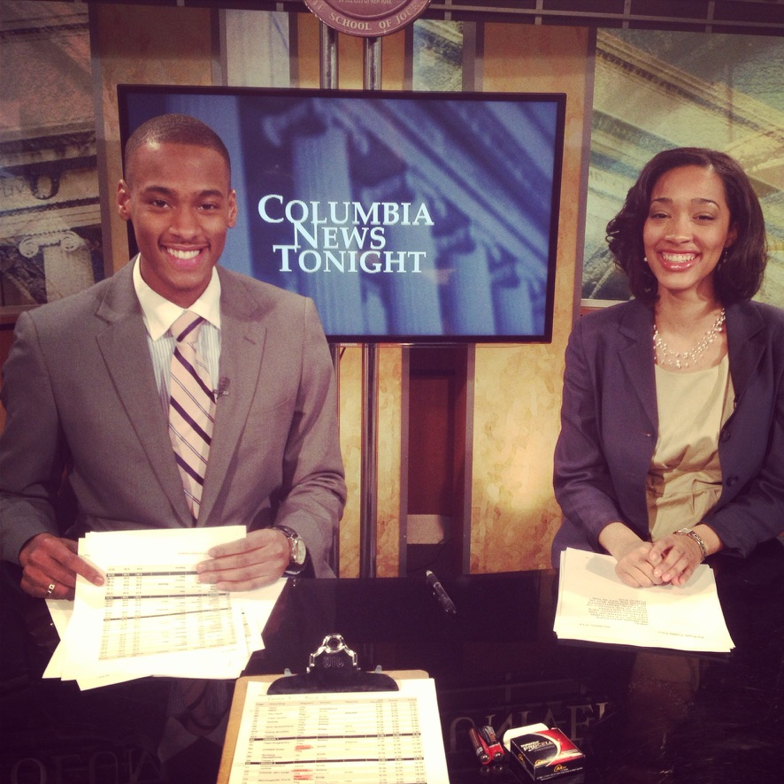 Stephon Dingle at the Columbia News Tonight anchor desk with his classmate.