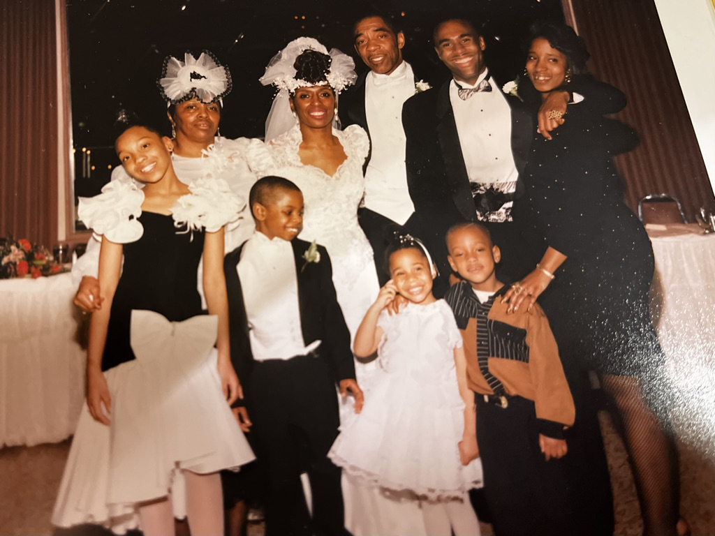 Young Stephon Dingle with his mother, Yulawnda, and father, David, at a family wedding.