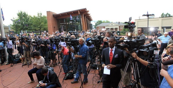 Stephon Dingle among cameras and reporters during a Charlottesville assignment.