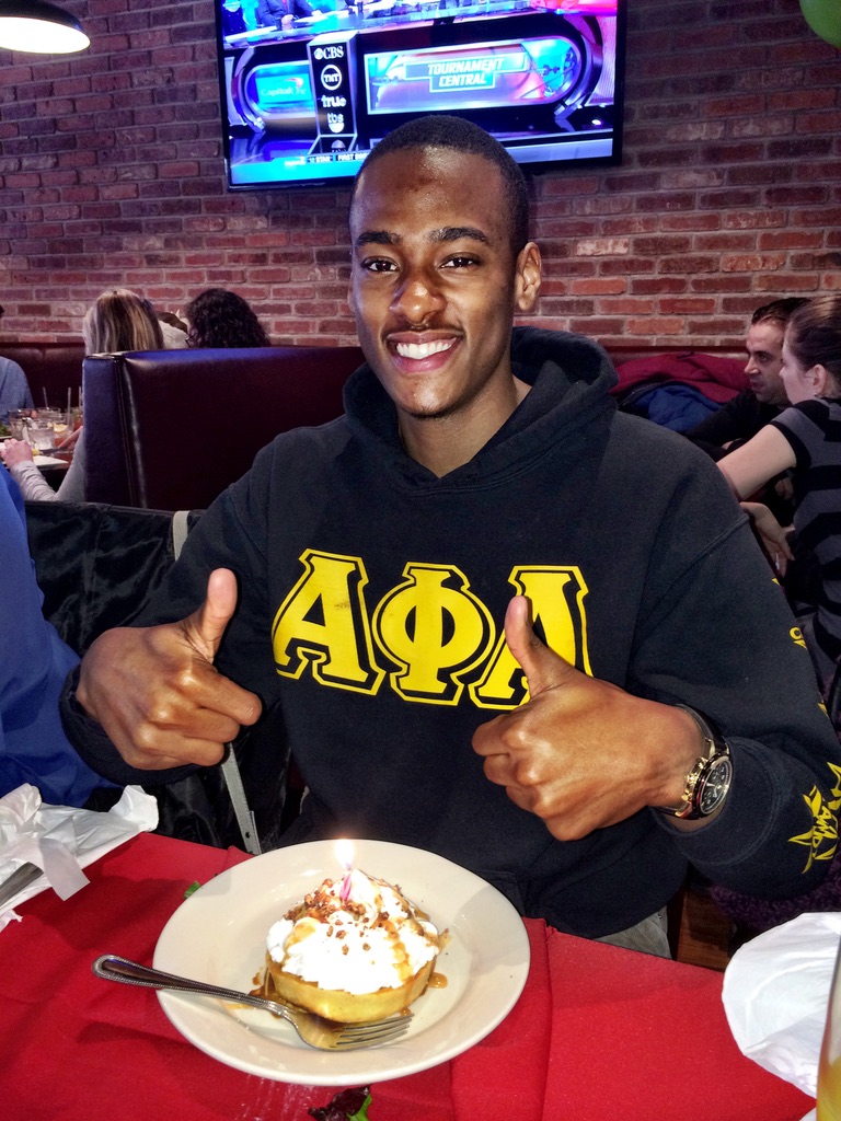 Stephon Dingle smiling in an Alpha Phi Alpha hoodie during his Harlem chapter in 2013.