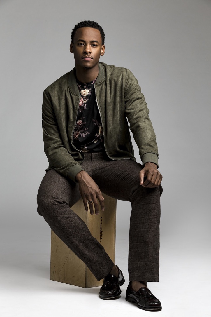 Stephon Dingle seated in a studio portrait.