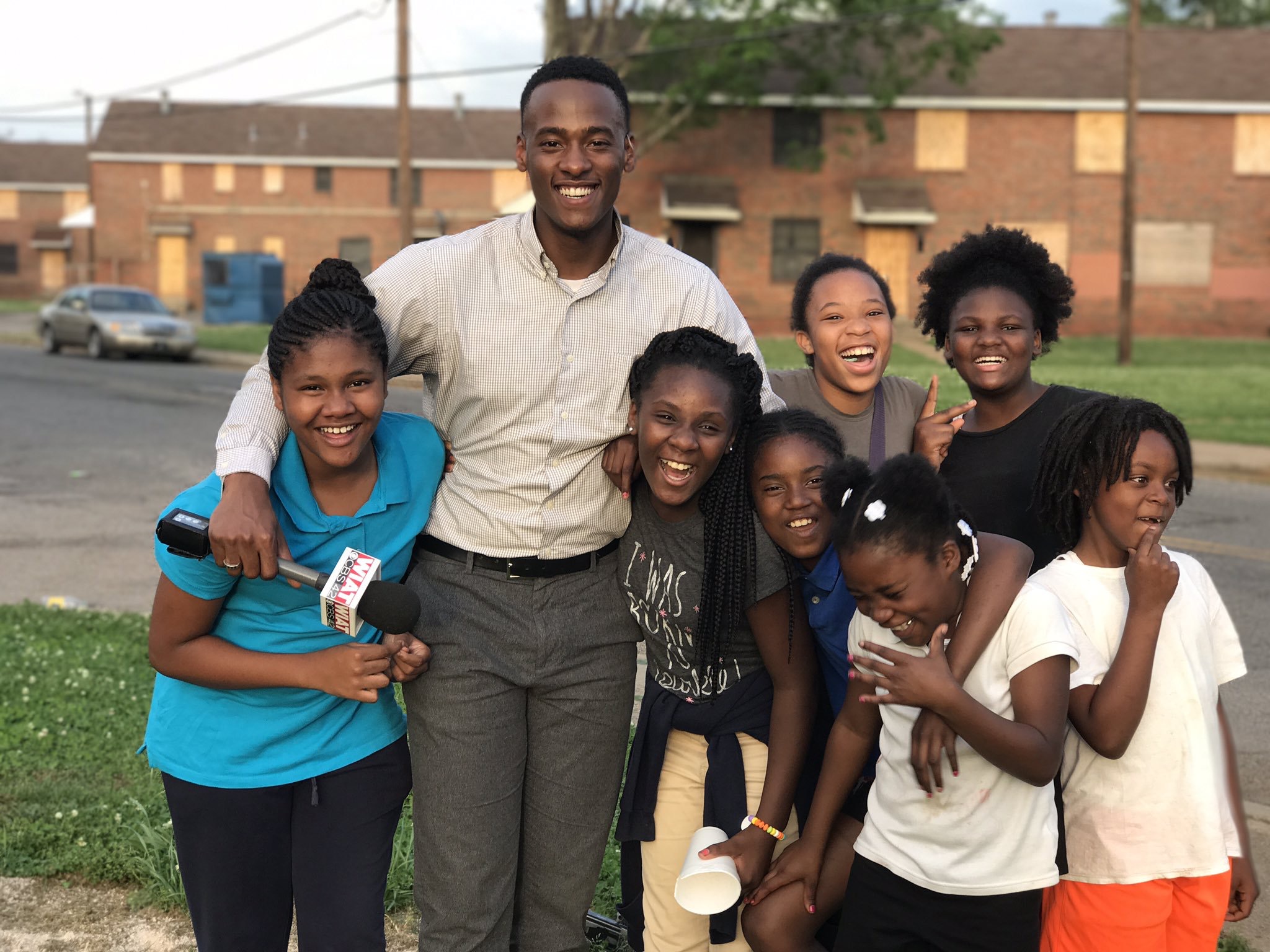 Stephon Dingle laughing with children at Loveman Village in Birmingham
