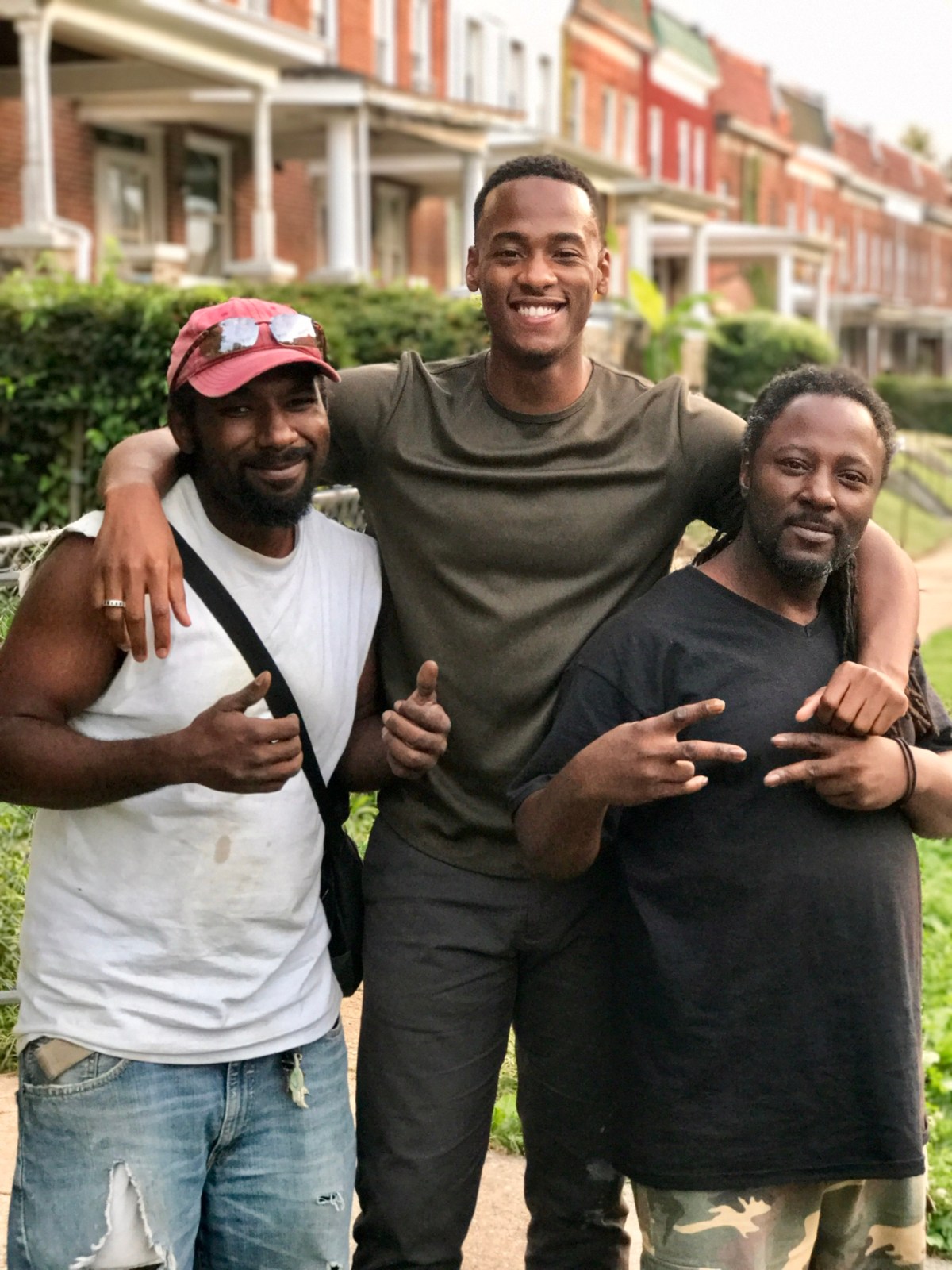 Stephon Dingle standing with his uncles Etienne and Gregory in Park Heights, West Baltimore.