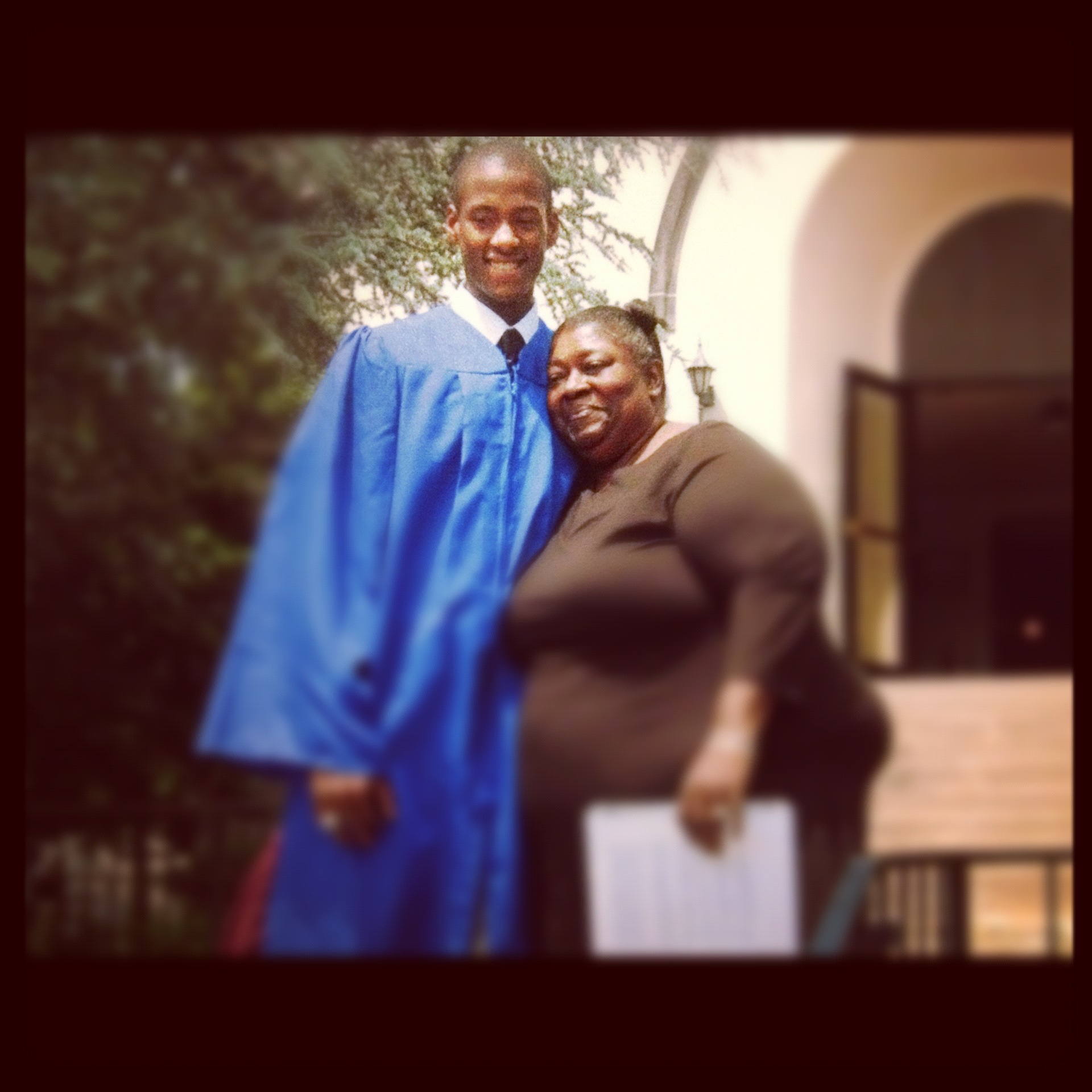 Stephon Dingle in his graduation gown beside his grandmother, Sheila Plato.