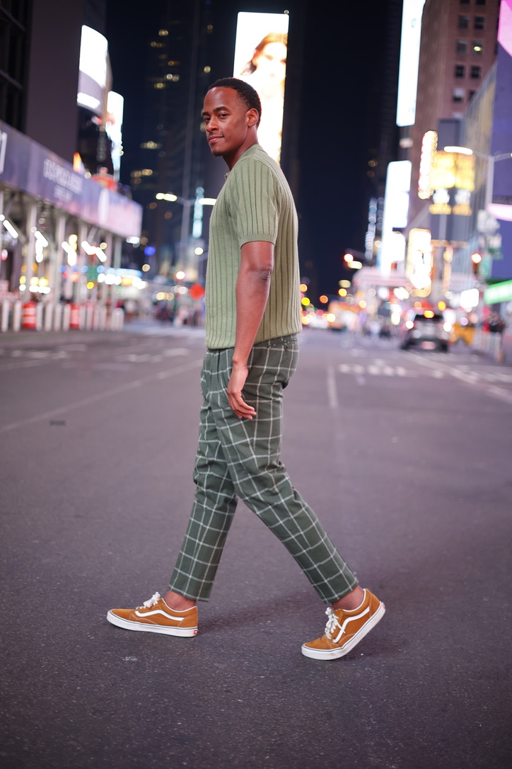 Stephon Dingle walking through Times Square at night.