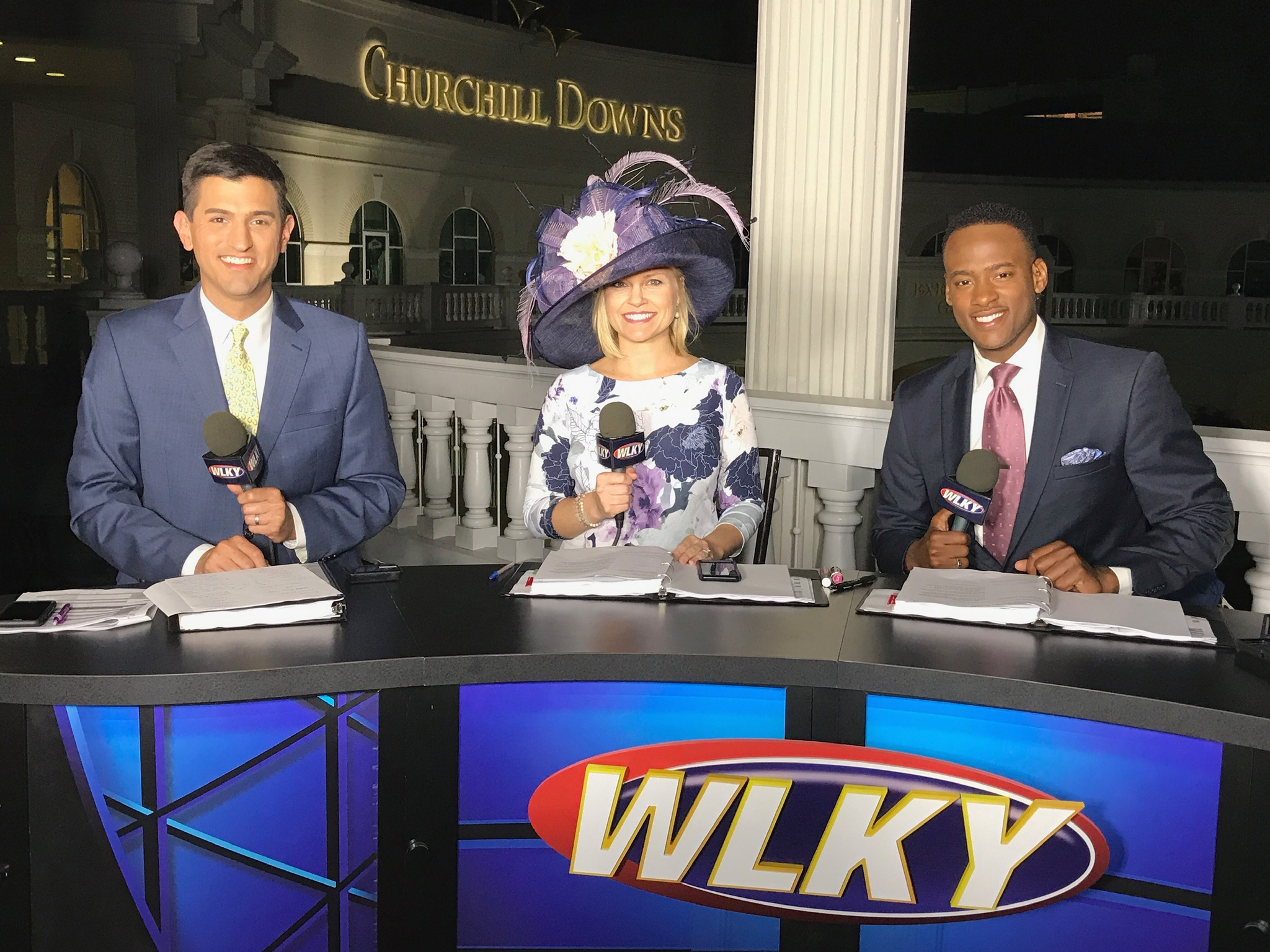 Stephon Dingle anchoring for WLKY with colleagues at Churchill Downs.